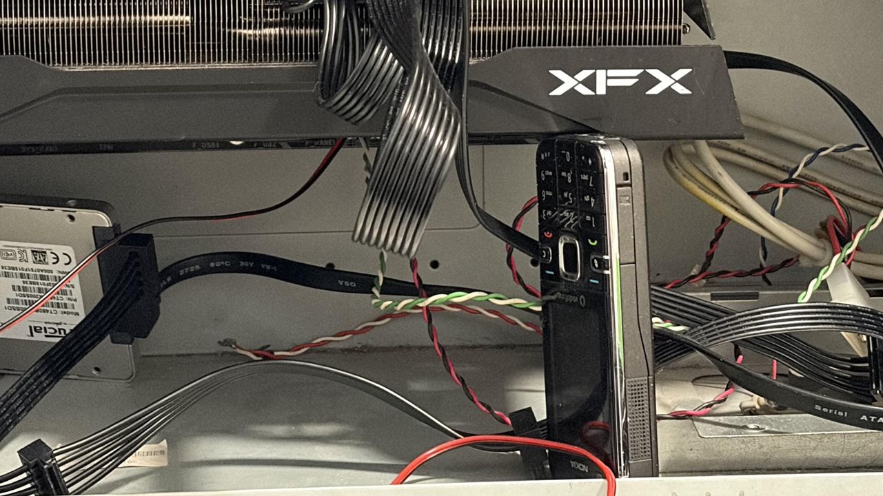 A player supports his graphics card with the most robust device in human history, which might even survive the end of the world